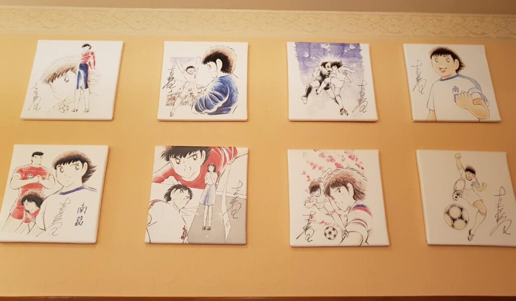 photo of characters in Captain Tsubasa on the wall of the captain tsubasa themed restaurant